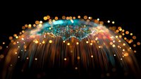 Glowing fiber optic strands emanate from center point creating magical light effect with orange and turquoise bokeh circles against dark background.
