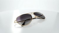 Pair of aviator sunglasses with gold metal frames and dark gradient lenses on white background, isolated for design use on merchandise and promotional materials.