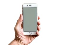 Male hand holding modern smartphone with blank screen isolated on white background. Clean mockup for app or web design presentation.