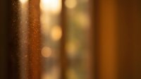 Warm golden bokeh lights with soft focus creating atmospheric background for luxury presentations and elegant design projects.