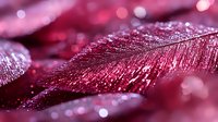 Sparkling pink feather with glittery texture and bokeh lights creating magical festive atmosphere for holiday decorations and glamorous design projects.