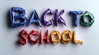 Colorful origami style text spelling "Back to School" with folded paper letters casting soft shadows on white background, modern educational concept.