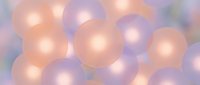 Soft pastel spheres in peach and lavender tones create a dreamy abstract background for banners, wallpapers, and digital design projects.
