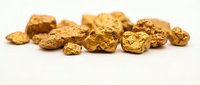 Golden nuggets scattered on white background isolated for mining investment wealth concept design projects.