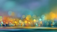 Abstract colorful bokeh lights background with warm and cool tones creating dreamy atmosphere for creative projects and digital designs.