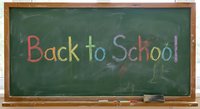 Back to School written in colorful chalk on green chalkboard with wooden frame for education and academic season preparation.
