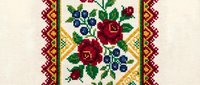 Traditional cross stitch embroidery pattern with red roses and blue berries in ethnic folk style border design for textile crafts and needlework projects.