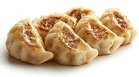 Pan-fried dumplings with crispy golden-brown bottom and pleated white dough tops arranged in row, showing traditional Asian potsticker preparation technique.