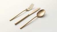 Gold matte cutlery set with fork, knife and spoon isolated on white background, elegant minimalist tableware for luxury dining.