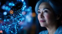 Mature Asian woman with blue hair gazing upward against dark background with magical glowing blue bokeh lights and sparkles creating dreamy atmospheric effect.