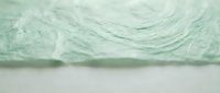 Soft green crumpled fabric texture with delicate folds and wrinkles, suitable for backgrounds, textile design, and creative projects.