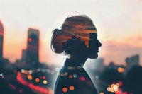 Female silhouette against urban sunset skyline with double exposure effect showing city lights and buildings merged with profile portrait, creating dreamy atmosphere.