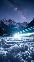 Snowy mountain landscape at night with glowing light trails streaking across frozen terrain beneath starry sky and milky way galaxy overhead.
