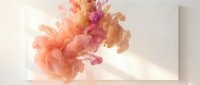 Abstract colorful smoke or ink clouds in orange and pink hues flowing dynamically against white background for creative design projects.