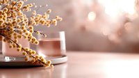Golden berry branches in glass vase with warm bokeh lights creating elegant home decor atmosphere for seasonal celebrations and interior design.