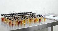 Laboratory test tubes with liquid samples arranged on white table for scientific research and chemical analysis in modern lab setting.