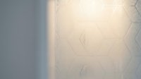 Modern minimalist interior wall with geometric hexagonal pattern tiles in neutral beige tones and soft natural lighting for contemporary home design.