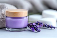 Purple cosmetic cream jar with wooden cap and fresh lavender flowers on light background, spa wellness skincare concept for natural beauty products.