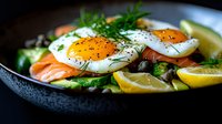 Poached eggs on smoked salmon with fresh dill, capers, and lemon slices served on dark plate. Fresh herbs and black pepper garnish create gourmet breakfast presentation.