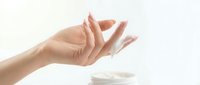 Female hand with manicured nails in open palm gesture against white background, suitable for healthcare, wellness, skincare and beauty product advertising.