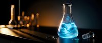 Laboratory flask with blue chemical solution on dark background with warm lighting for scientific research and experimentation.