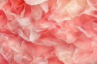 Delicate coral pink ruffled fabric texture with soft flowing waves and ethereal translucent layers creating romantic dreamy background pattern.