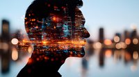 Double exposure silhouette of young Asian man merged with illuminated city skyline at night, showing urban lights and reflections creating dreamy atmosphere.