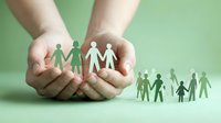 Hands protecting paper cutout family figures on green background symbolizing care, support and community protection for social services campaigns.
