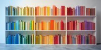 Colorful books arranged in rainbow spectrum order on white modern bookshelf against light wall, creating vibrant gradient display for home library or bookstore.