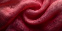 Luxurious red fabric with delicate woven texture creates elegant waves and folds, featuring subtle sheen and intricate crosshatch pattern in deep crimson tones.