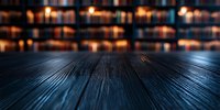 Dark wooden table surface with blurred warm candlelight and bookshelves in background creating atmospheric mood for product photography and presentations.