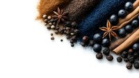 Aromatic spices and ingredients scattered on white background with cinnamon sticks, star anise, black peppercorns and colorful powder spices for cooking.