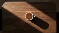Cup of coffee on wooden table with natural sunlight and shadow, overhead view for beverage, lifestyle and morning routine concepts.