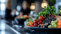 Fresh strawberries, blueberries and grapes on dark plate with nuts and seeds, selective focus on berries. Healthy breakfast or snack concept on blurred background.