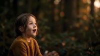 Young girl with dark hair and fair complexion wearing mustard yellow ribbed sweater, looking upward with surprised expression in autumn forest setting with warm golden lighting.