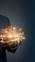 Businessman holding glowing digital city with financial charts and graphs for business growth, investment, and economic development concepts.