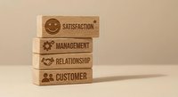 Wooden blocks stacked displaying business concepts including satisfaction, management, relationship and customer service icons for corporate training.