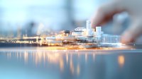 Illuminated modern waterfront cityscape with glowing reflections on calm water surface at dusk, featuring contemporary architecture and soft bokeh effect.