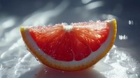 Fresh juicy grapefruit slice on dark background with water drops and dramatic lighting, macro food photography showing vibrant red flesh and citrus texture.