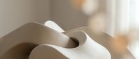 Abstract flowing curves in warm beige tones creating organic sculptural forms with soft lighting and shadows for modern interior design and artistic projects.