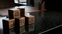 Wooden blocks with carved Asian characters stacked on dark granite surface, suitable for educational materials, language learning, and cultural design projects.