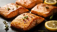 Grilled salmon fillets with lemon slices and fresh herbs on dark stone background, juicy fish steaks with golden crust and citrus garnish for seafood menu.