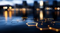 Glowing hexagonal network pattern floating over reflective water surface against blurred city lights at dusk, representing digital connectivity and innovation.