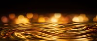 Flowing golden liquid metal waves with warm bokeh lights creating luxurious abstract background for premium design projects and elegant presentations.