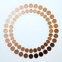 Circular arrangement of foundation makeup samples showing diverse skin tone spectrum from light to dark shades for cosmetic color matching and beauty industry.