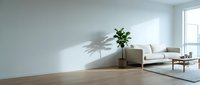 Bright minimalist living room with wooden floor, white sofa, potted plant, and natural sunlight casting shadows on walls for modern interior design projects.
