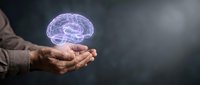Businessman holding glowing digital brain hologram in hands, representing artificial intelligence, innovation, and technology solutions for business growth and development.