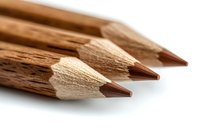 Macro view of natural wooden pencils with brown graphite tips arranged in diagonal composition on white background, showing texture and craftsmanship detail.