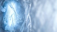 Cracked ice surface with intricate frost patterns and crystalline textures creating abstract winter background for seasonal designs and cold weather concepts.