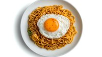 Appetizing stir-fried noodles topped with sunny side up egg on white ceramic plate, overhead view against white background. Asian fusion cuisine.
